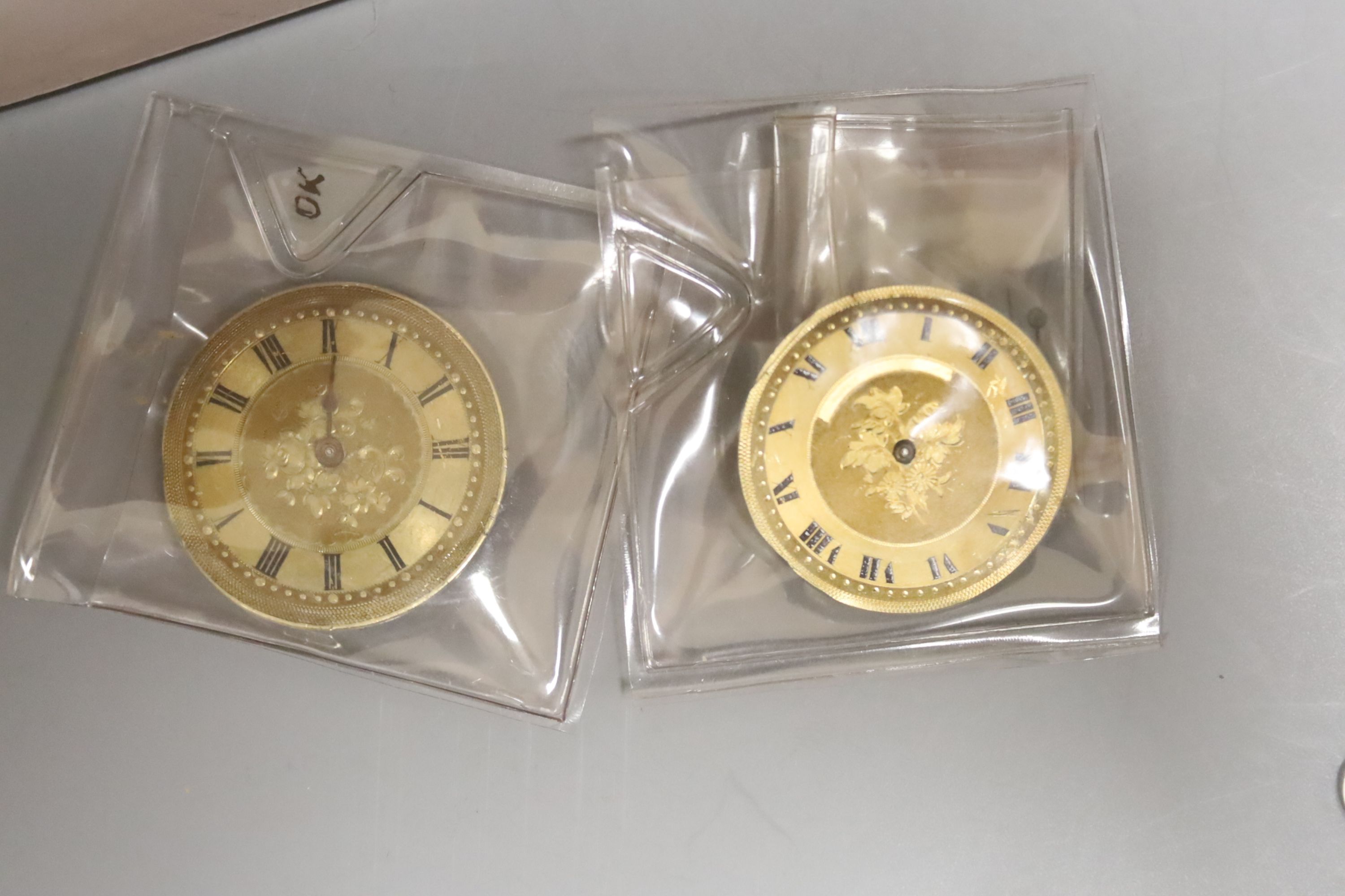 Thirteen assorted base or white metal pocket watches, a Cyma wristwatch and two movements.